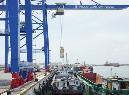 Gần 80% lượng hàng luân chuyển từ các cảng khu vực TP. Hồ Chí Minh và Bà Rịa - Vũng Tàu đến các tỉnh thành, địa phương trong khu vực Đồng bằng sông Cửu Long vẫn phải vận tải bằng đường bộ với chi phí trung bình tăng thêm khoảng 8 đến 10USD/tấn, làm giảm tính cạnh tranh của hàng hóa đặc biệt đối với các loại hàng hóa nông, thủy sản. Trong ảnh: Bốc dỡ hàng hóa từ cảng xuống xà lan tại cảng Tân Cảng - Cái Mép.